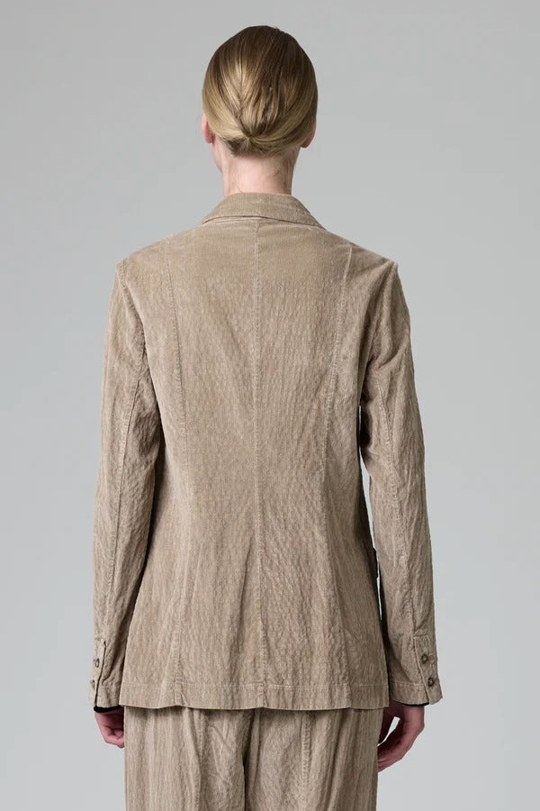 Back view of camel regular fit jacket on model wearing camel pants, against a grey background.