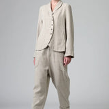 Front view of chalk herringbone jacket on model wearing chalk pants, against a grey background.