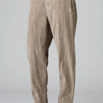 Side view of camel regular fit trousers on model wearing black top and boots, against a grey background.