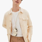 Back view of white valextra glasses case with lanyard on model wearing white t-shirt with orange trousers, against a white background.