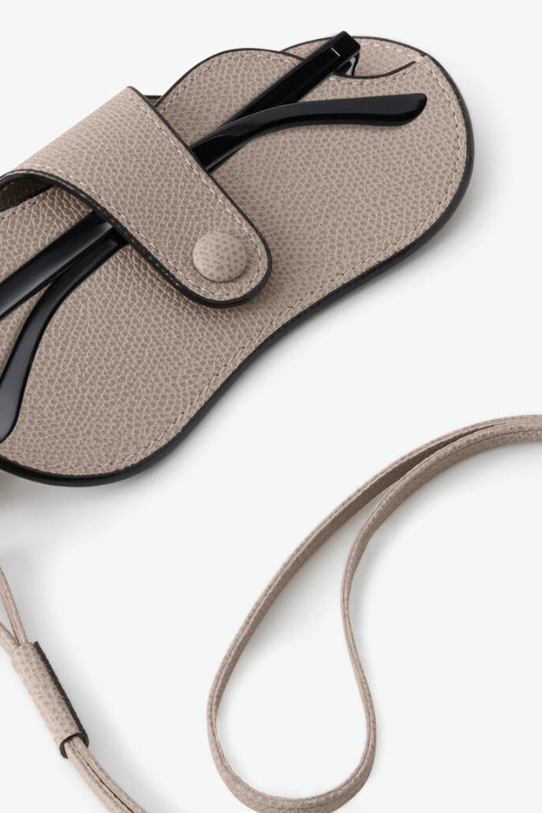 Back alternate view of nude glasses case with lanyard on white background, with no model shown.