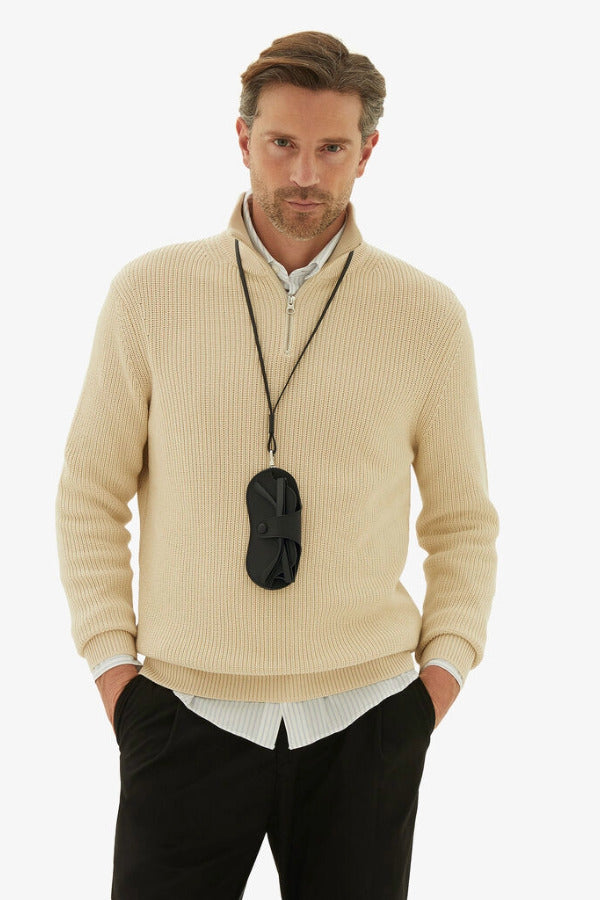 Back alternate view of black glasses case with lanyard on model wearing yellow sweater and black trousers, against a white background