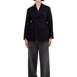 Front view of black sabrina db jacket on model wearing grey pants, against a white background.