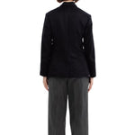 Back view of black sabrina db jacket on model wearing grey pants, against a white background.