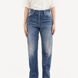 Front view of damaged social sculpture w18 jean on model wearing white t-shirt and sneakers, against a white background.