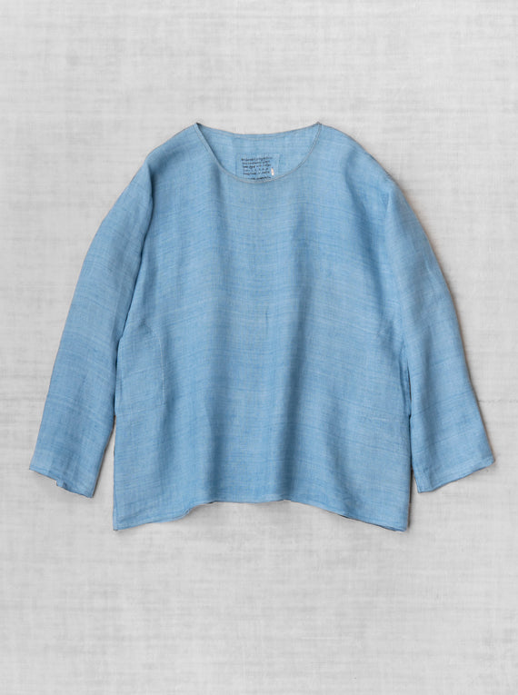 Front view of denim tunisian top on flat surface, against white background, with no model shown.