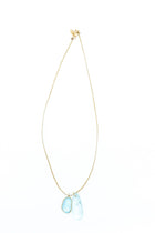 Pippa-Small-18K-yellow-gold-blue-topaz-collette-pendant-on-cord-amarees