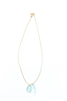 Pippa-Small-18K-yellow-gold-blue-topaz-collette-pendant-on-cord-amarees